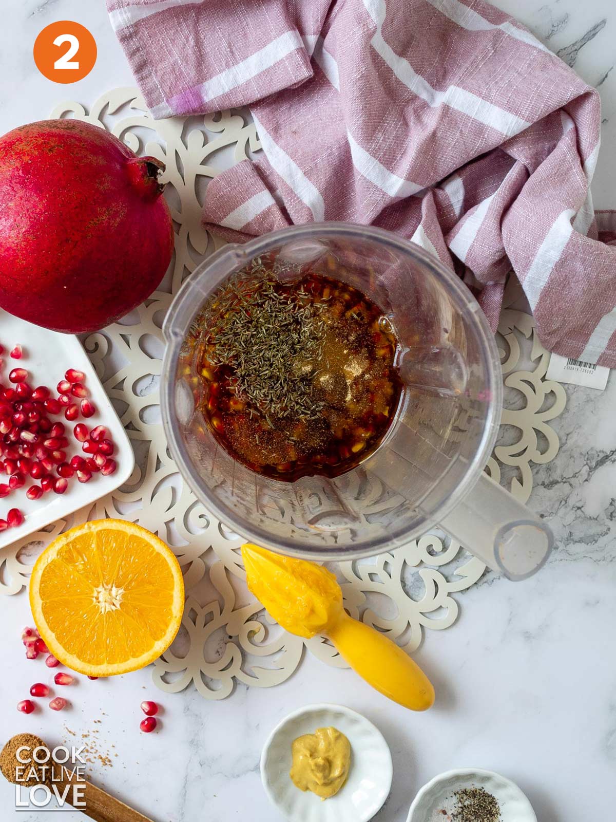The ingredients in a blender to make pomegranate vinaigrette.