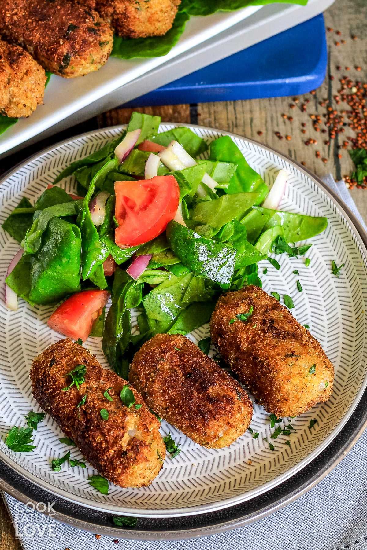 Vegetarian croquettes on plate with small salad.