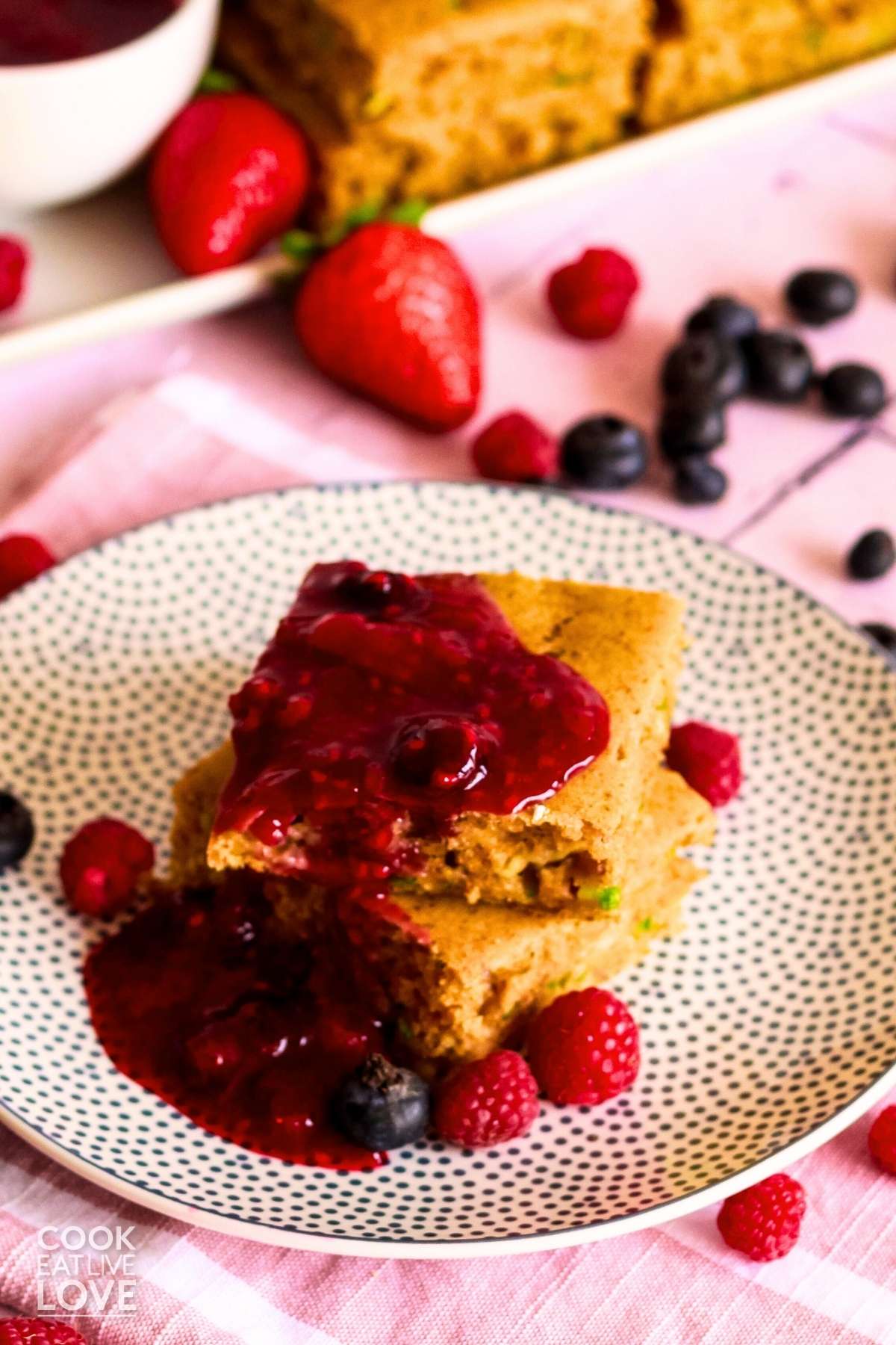 Close up front view of stacked vegan sheet pan pancakes with berries.