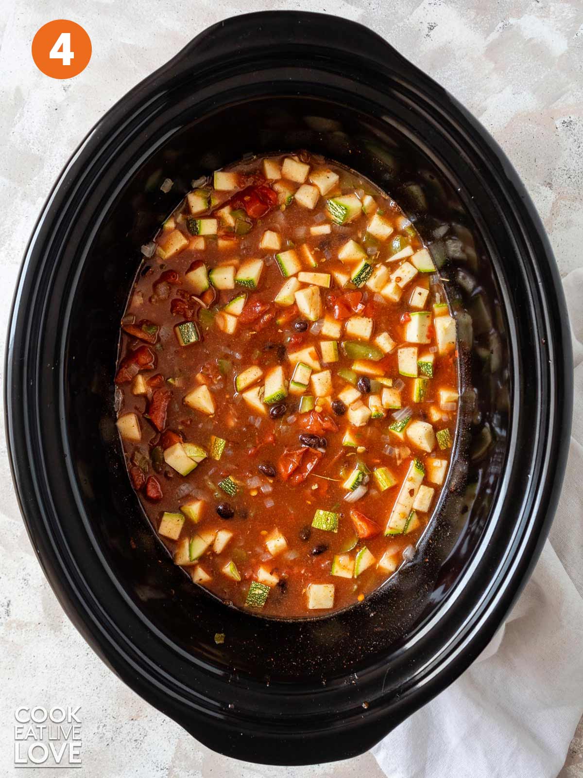 Everything in the slow cooker ready to cook.