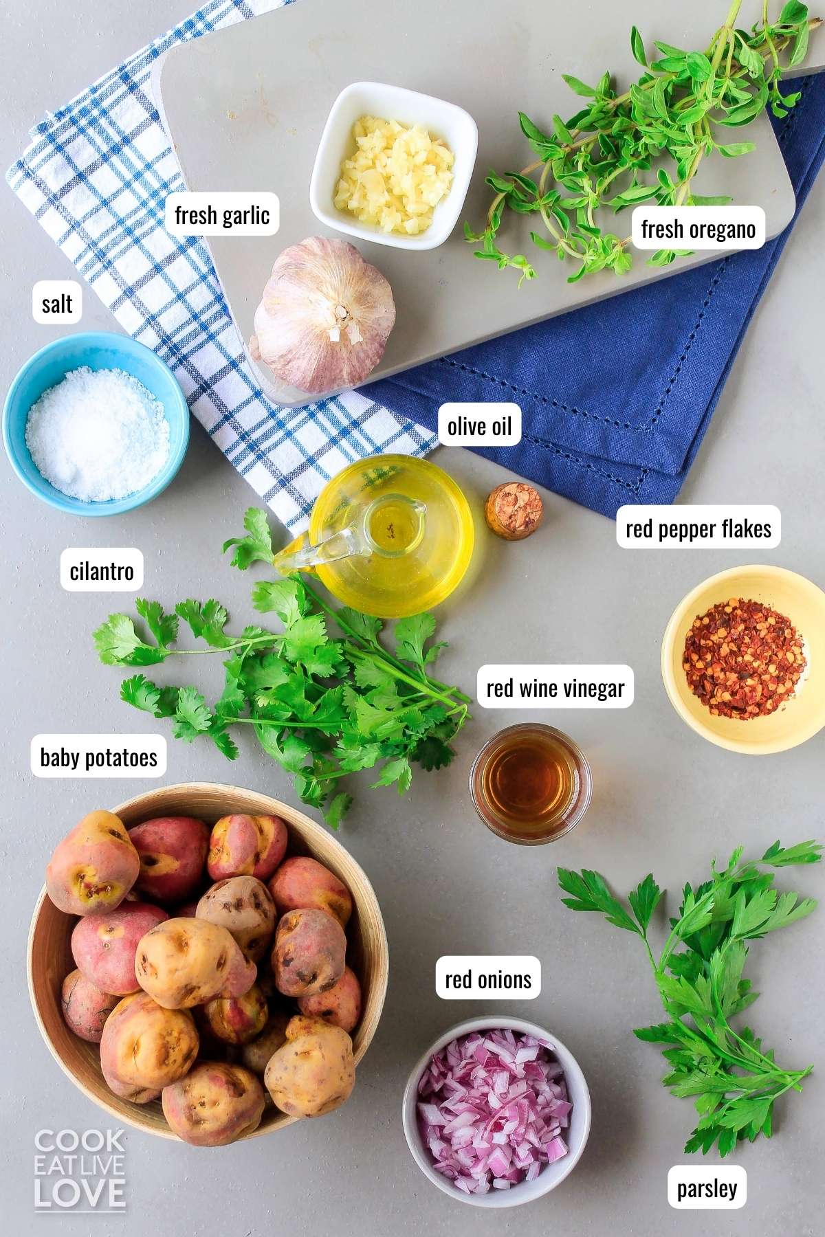 Ingredients to make smashed red potatoes on a table with text labels.