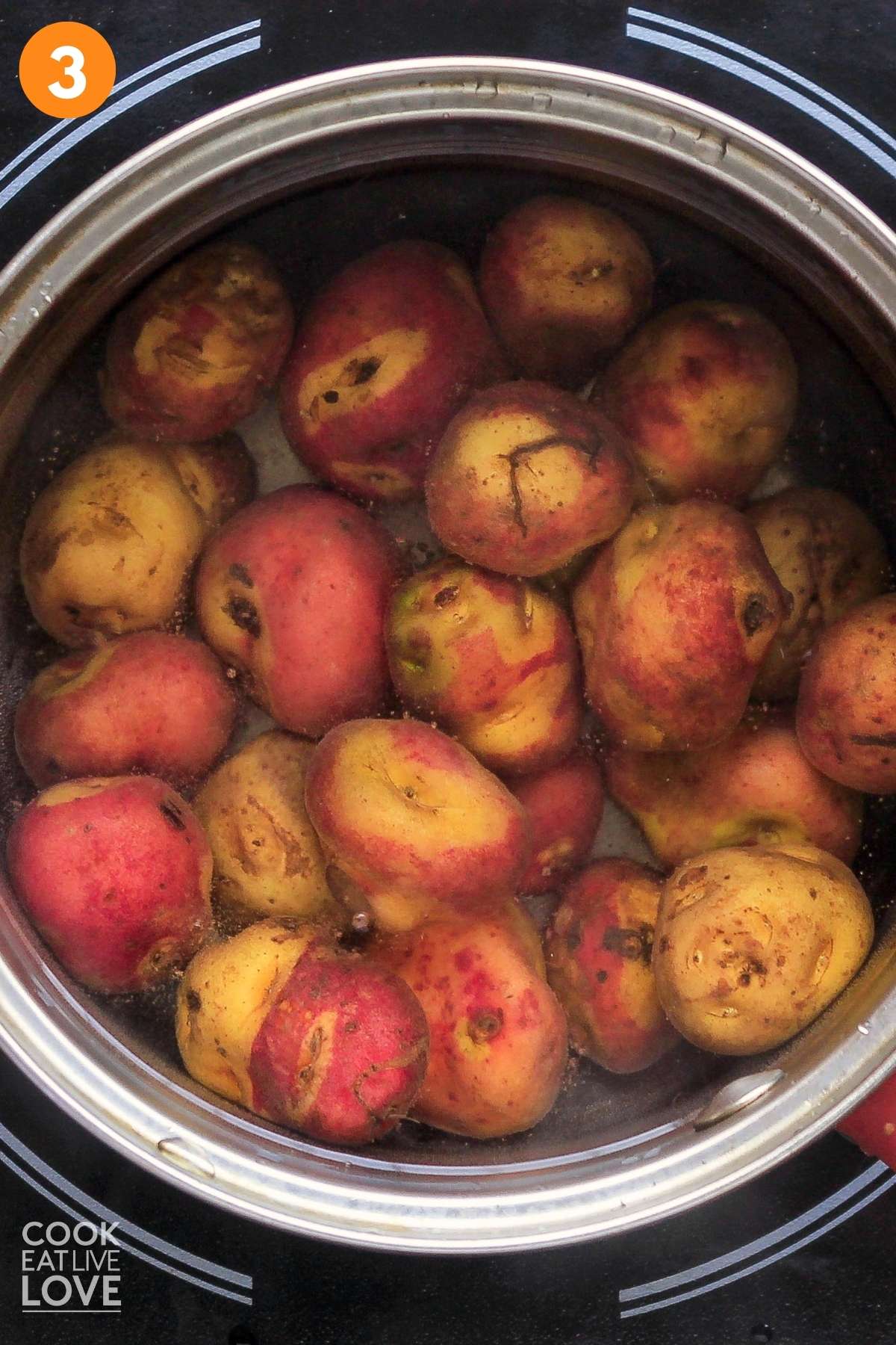 Potatoes cooking in a pot of water.