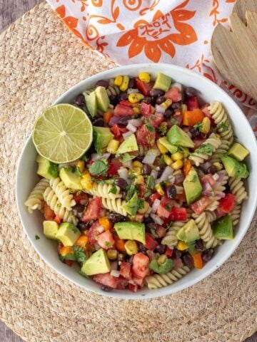 A bowl of Southwest pasta salad with black beans, veggies, and a homemade dressing.