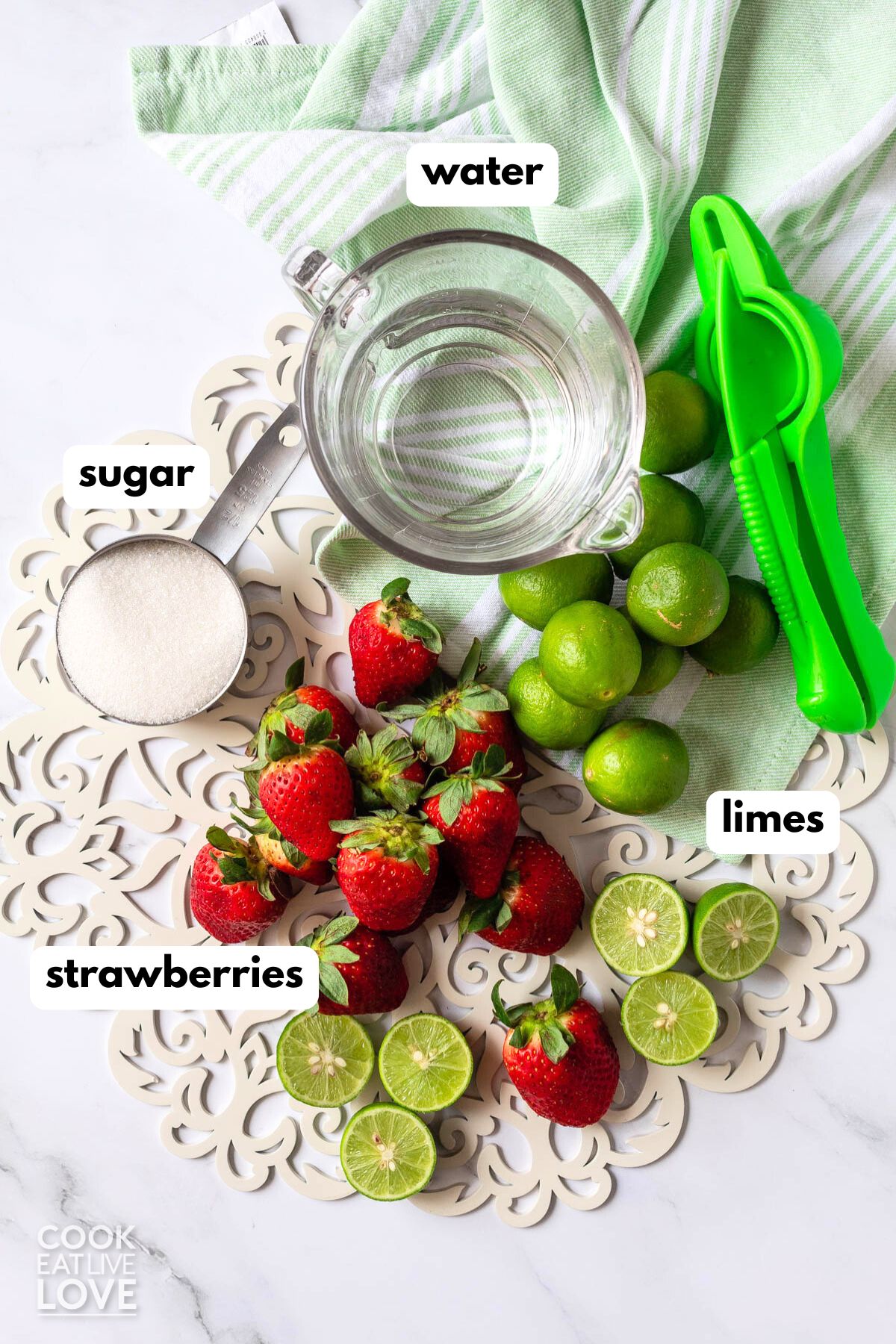 Ingredients to make strawberry limeade on the table.