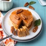 A plate with a stack of sweet potato pancakes with a forkful on the side.