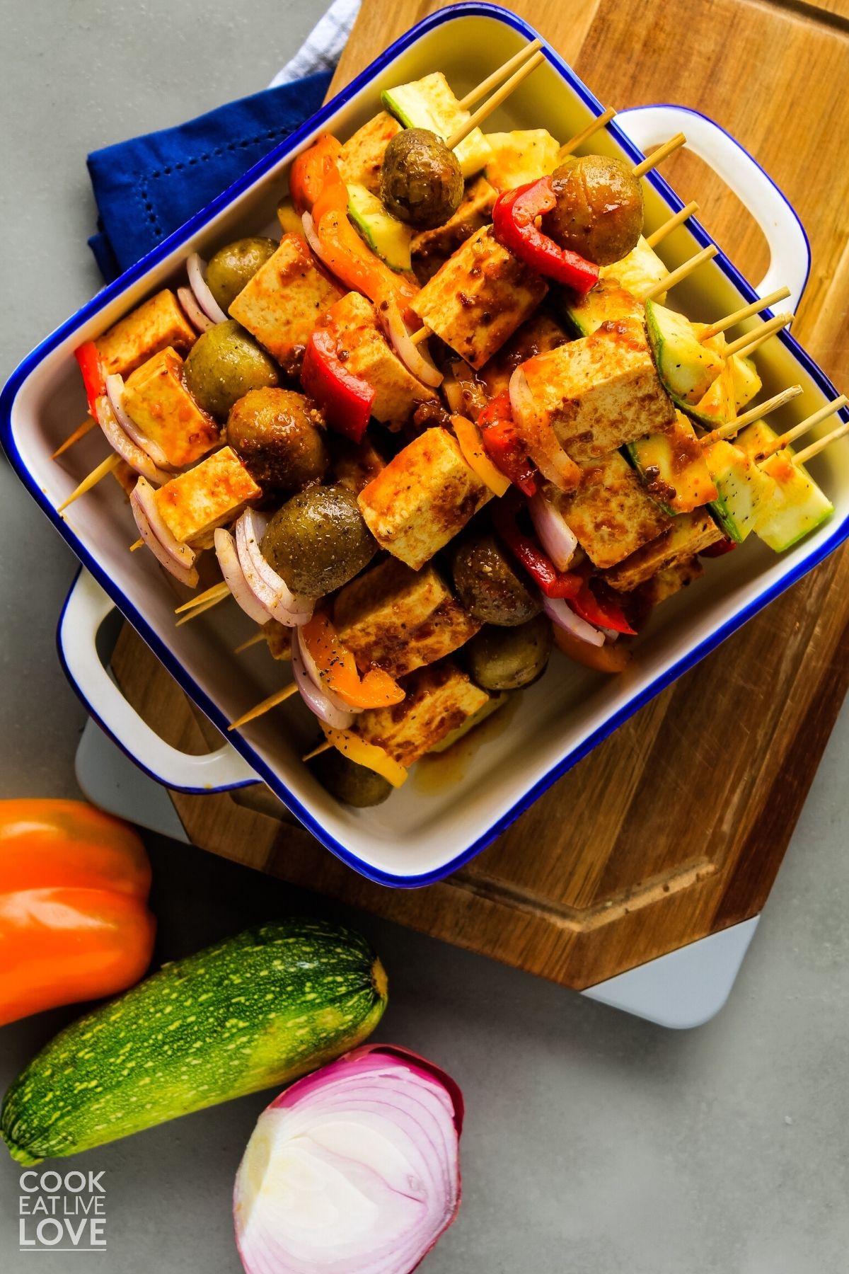 Vegetables and tofu are threaded onto skewers and ready for the grill.