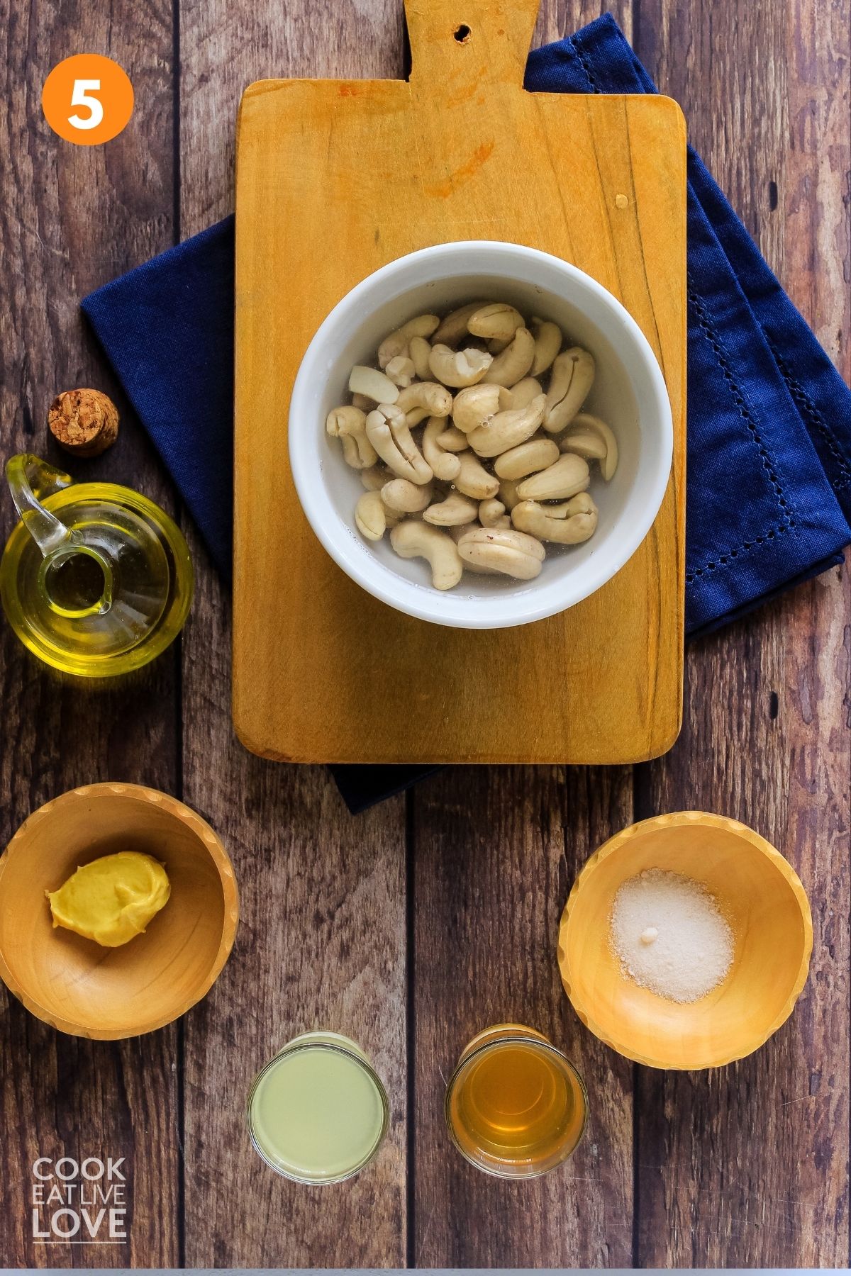 Soaked cashews in water and other ingredients gathered to make vegan roasted garlic aioli.