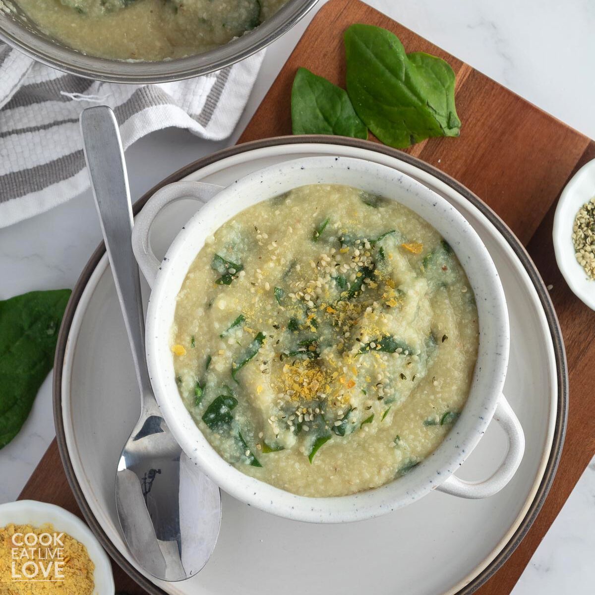 Perfect breakfast bowl of spinach garlic grits with poached egg