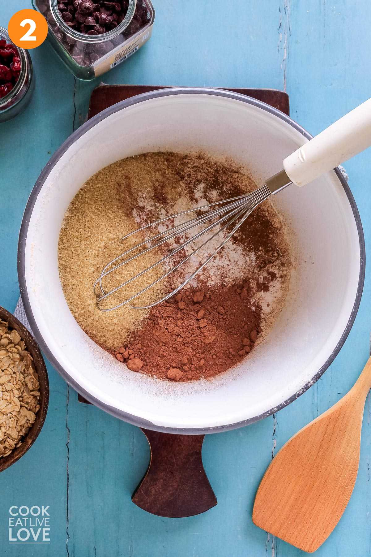 Dry ingredients are combined in a white bowl with a whisk to mix.