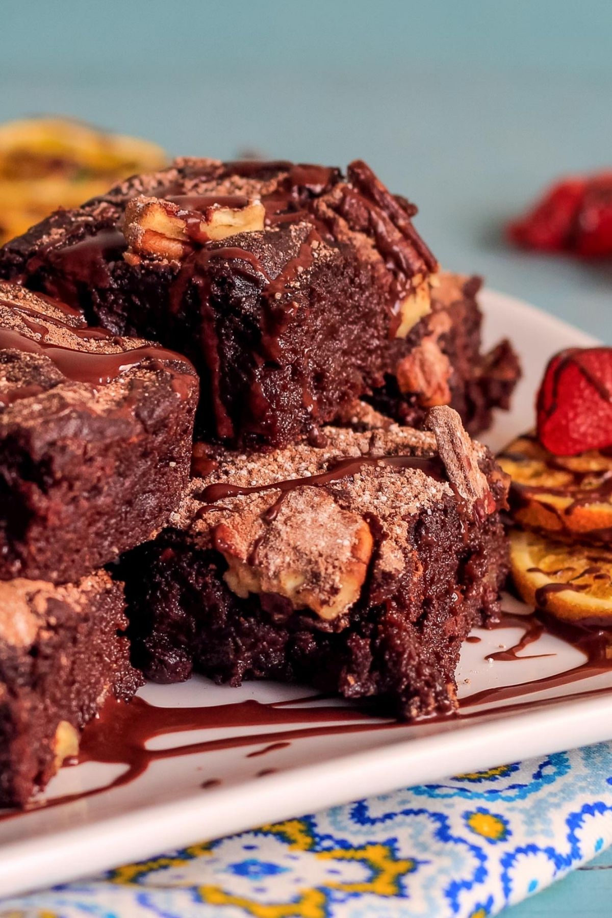 A stack of vegan date brownies on a plate.