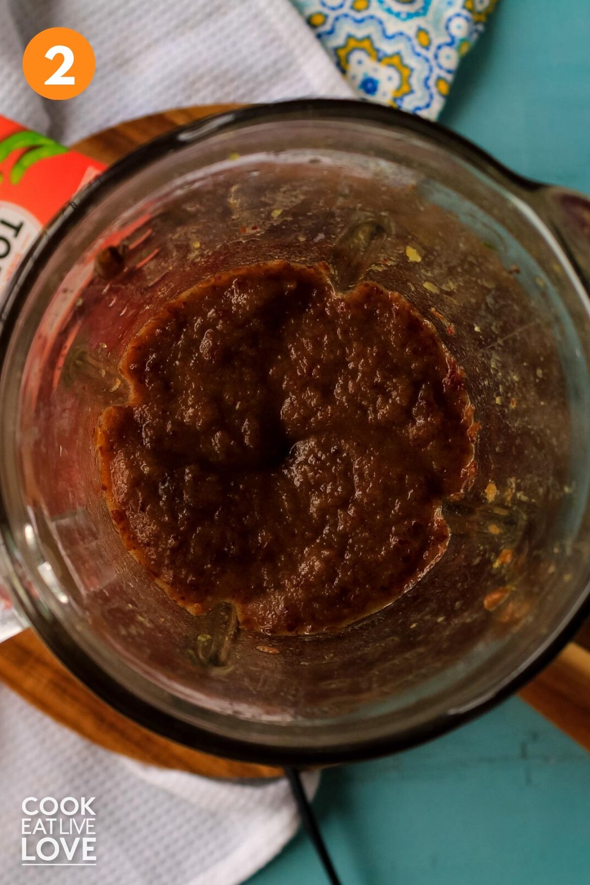 Blender on counter with pureed dates inside.