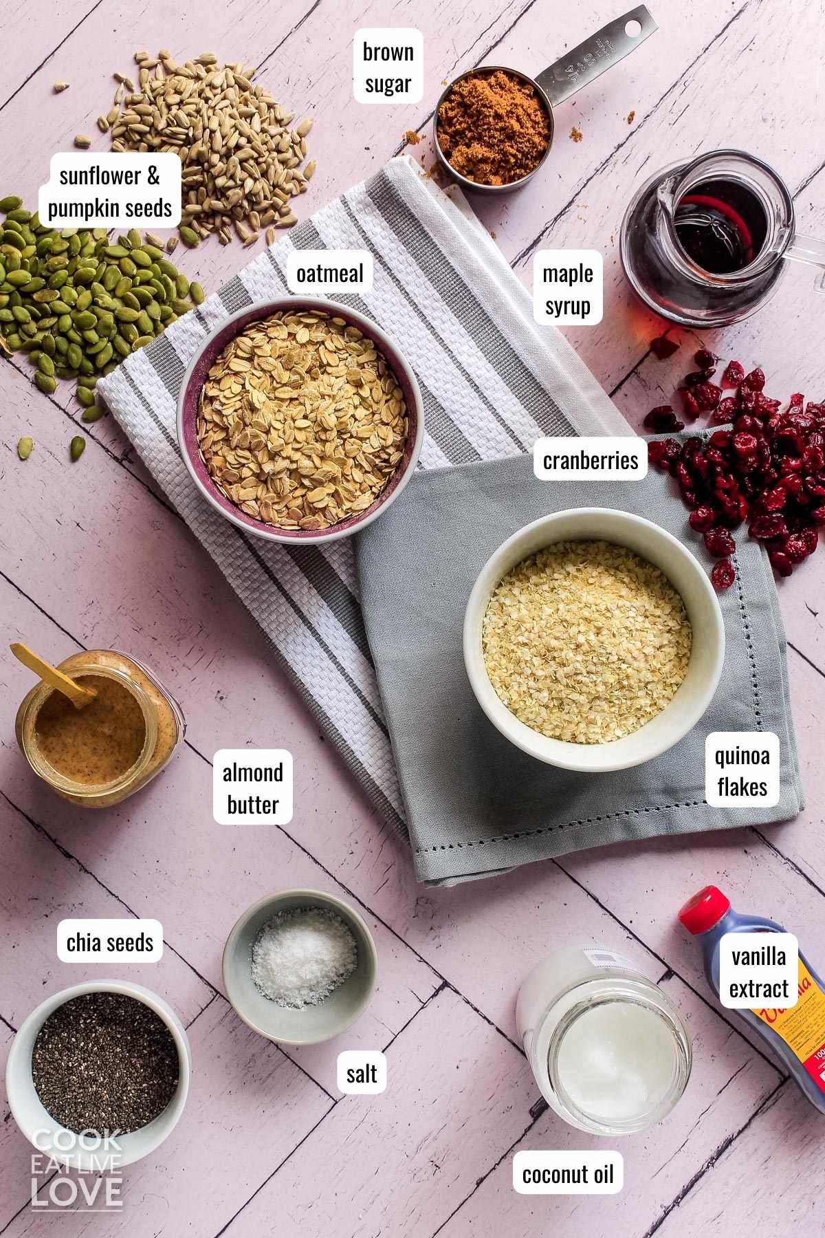Overhead view of ingredients to make vegan breakfast bars on pink backdrop with text labels for each.