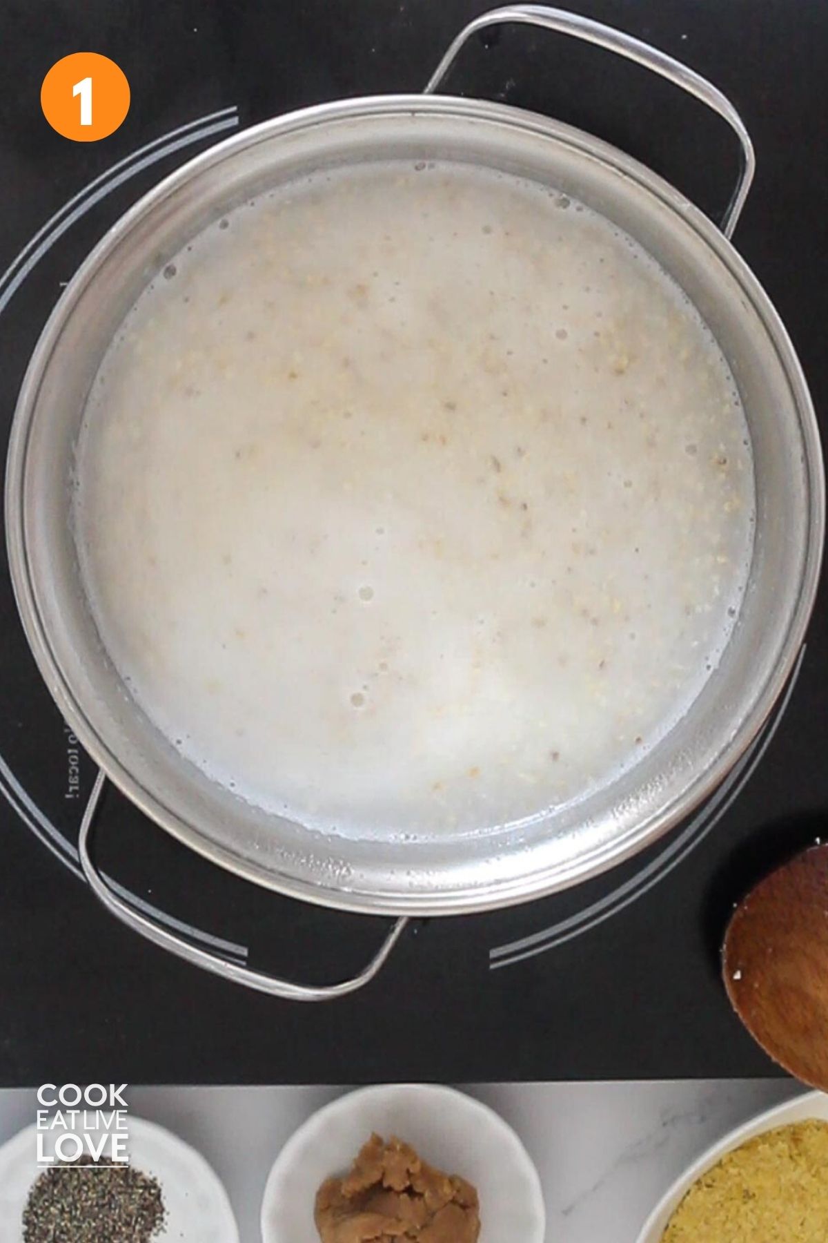 Grits added to boiling water in a pot.