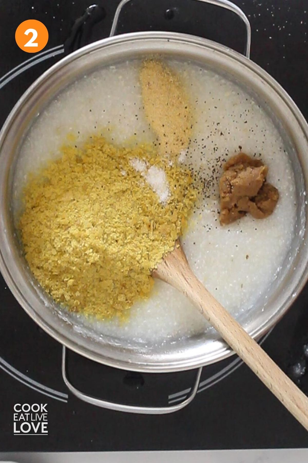 Nutritional yeast, miso, and seasoning added to vegan cheesy grits.