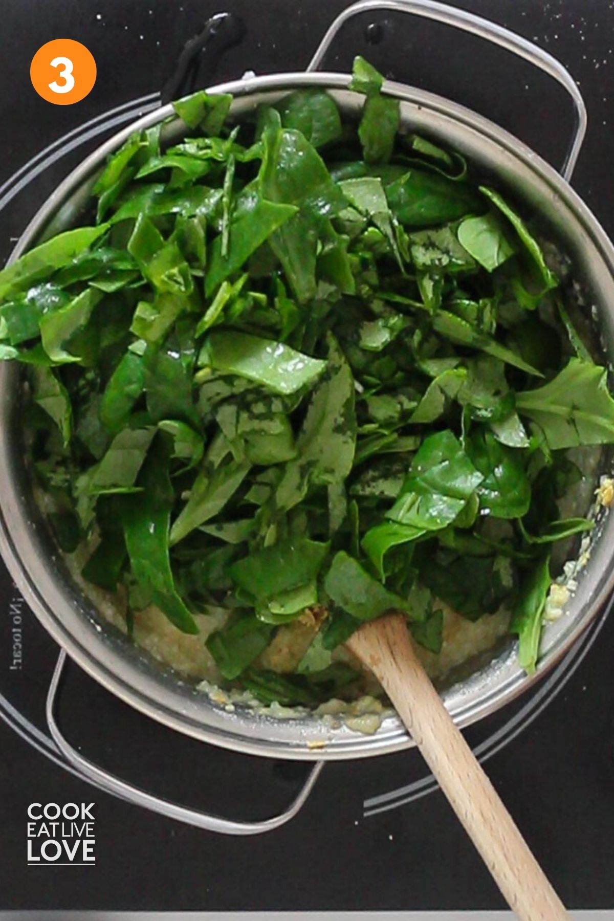 Spinach is added to the pot of grits.