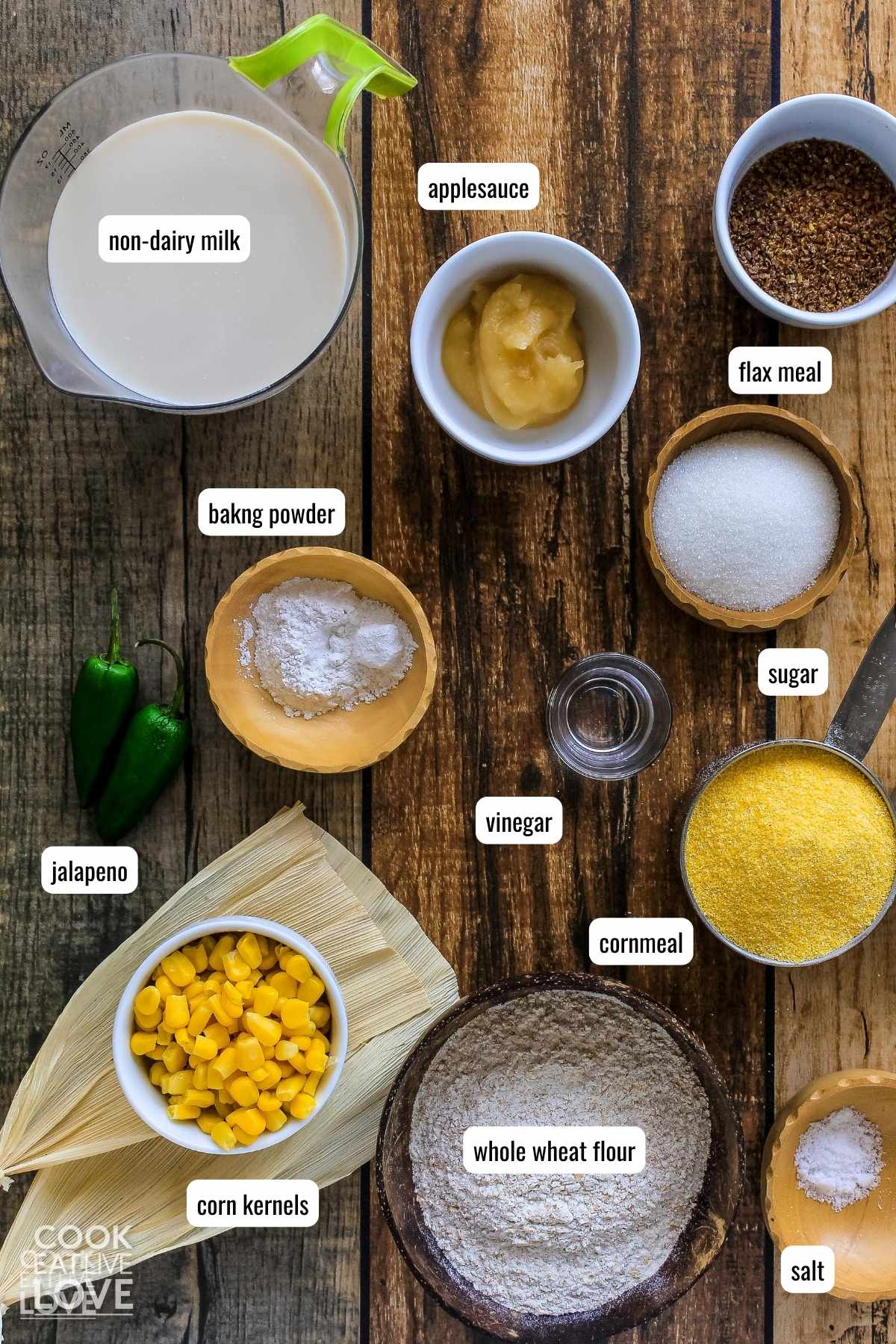 Ingredients with labels to make egg free cornbread on the table before mixing.