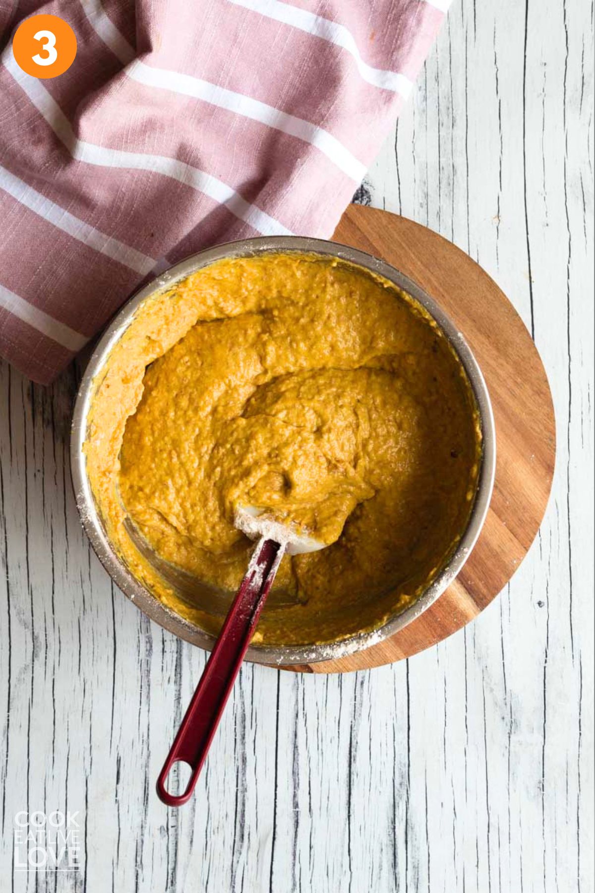 Pumpkin muffin batter mixed in a bowl.