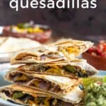 Pin for pinterest of quesadillas ready to eat with guacamole and salsa. Text on top: "Sheet pan quesadillas, bean & roasted veggies"