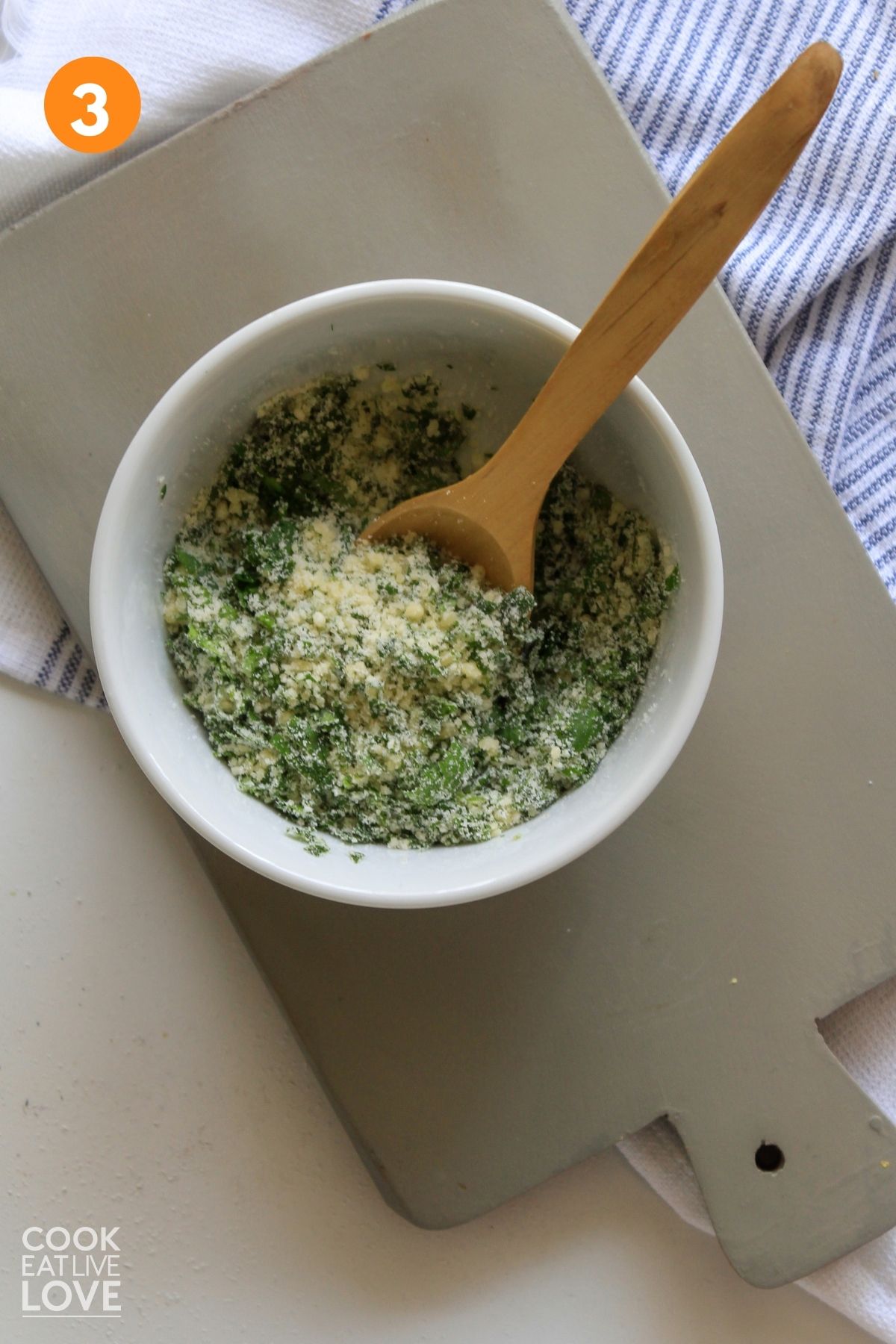 Cheese and herb topping in a bowl.