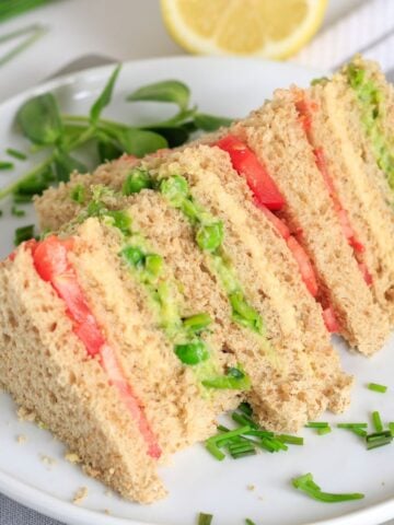 Vegan sandwich cut into triangle to show layers