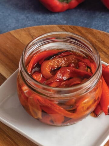 A small jar of air fryer roasted red peppers on the table.