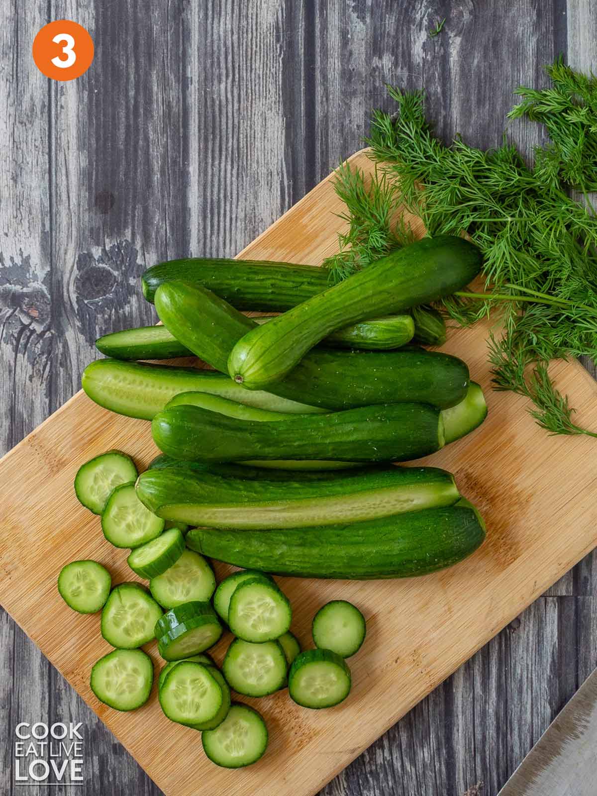 Cucumbers cut in half and in slices on a cutting board.