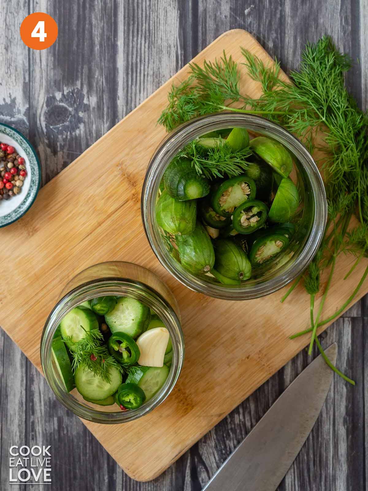Cucumbers and other ingredients in jars.