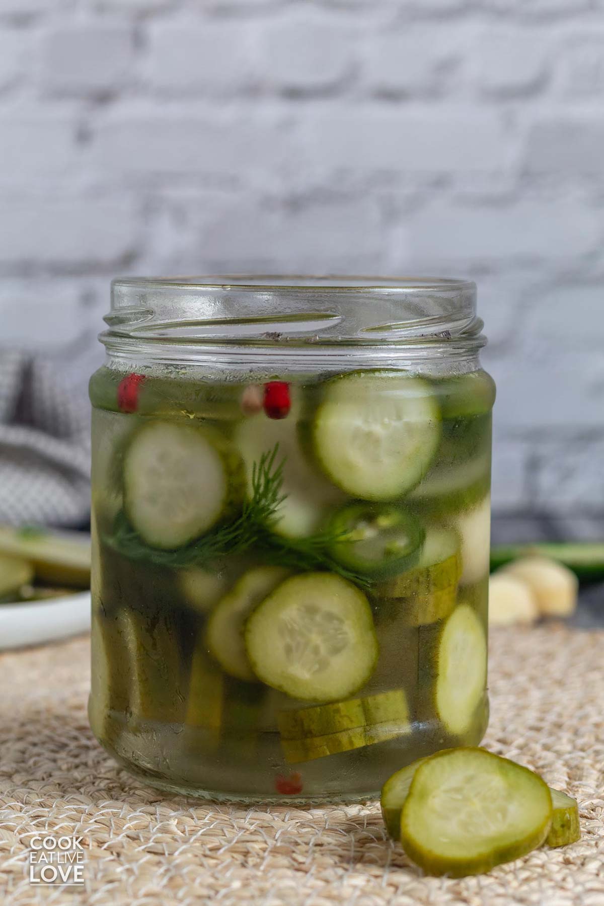 A jar of small batch refrigerator dill pickles on the table.