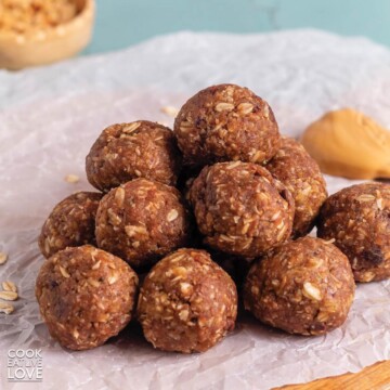A stack of 4 ingredient peanut butter balls on a piece of white parchment.