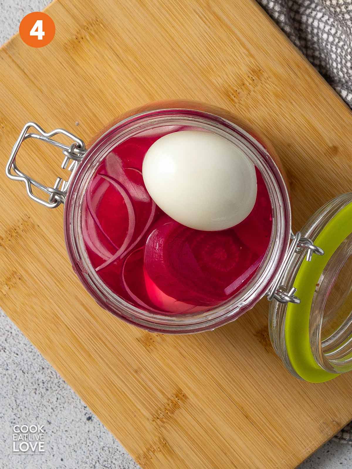 Beets, egg, and brine in a jar.