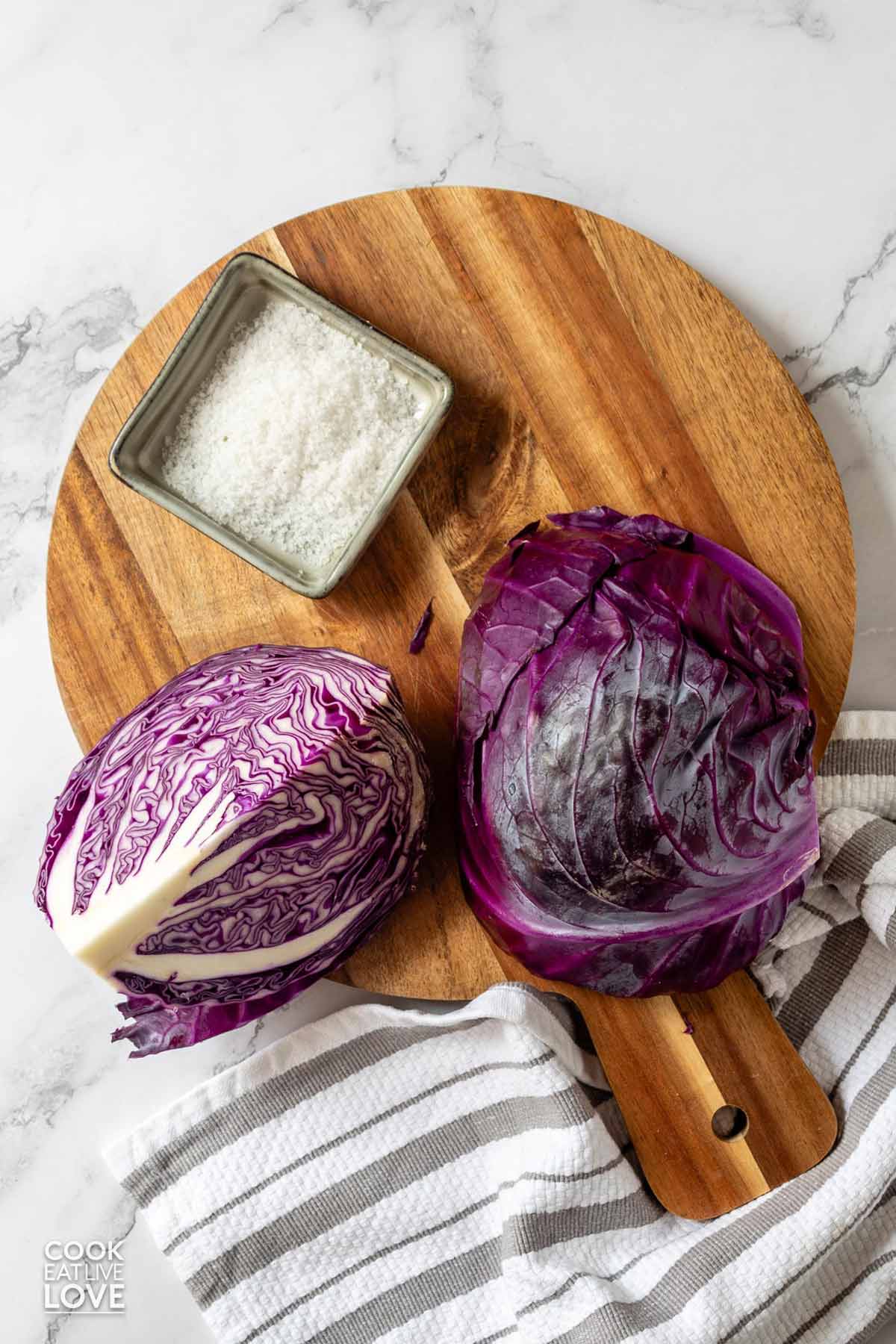 Ingredients to make sauerkraut with red cabbage on the table.