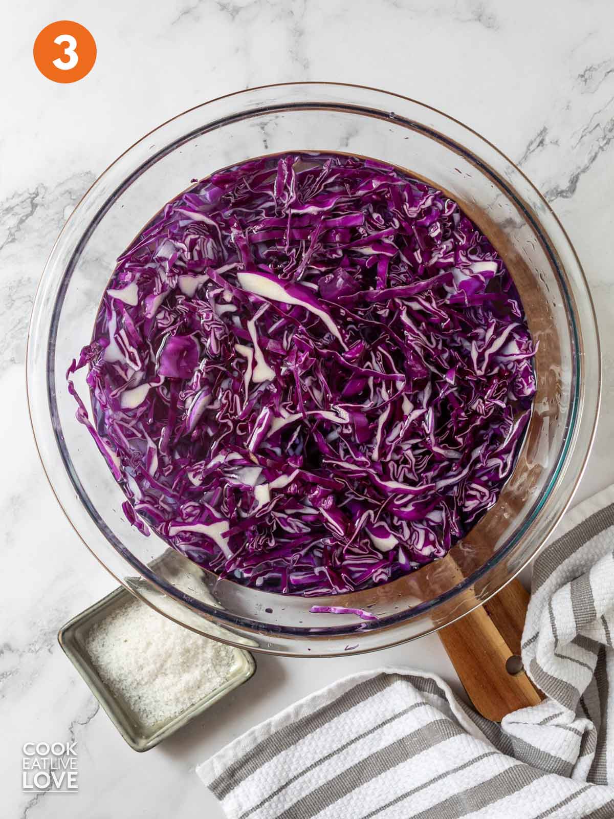Purple cabbage in a bowl of water.