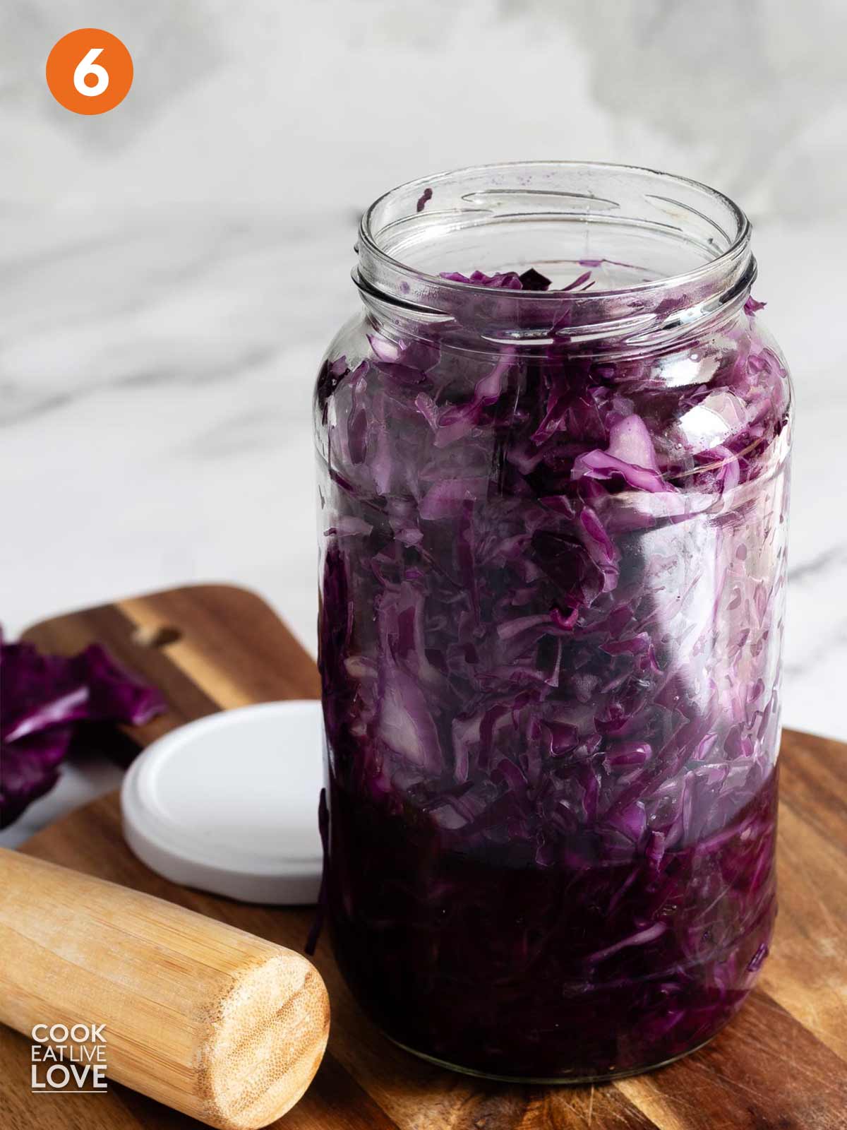 Red cabbage in a jar on the counter.
