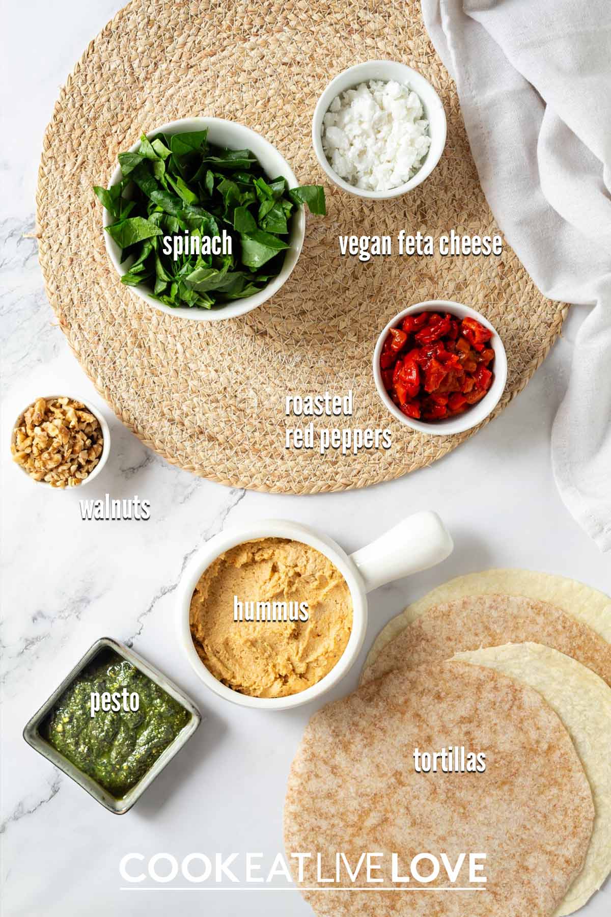 Ingredients to make vegan pinwheels on the table with text labels.