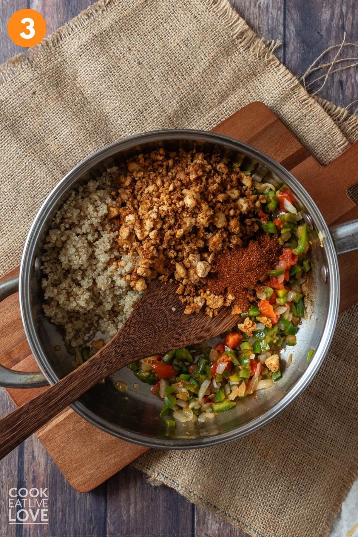 Tofu crumbles and seasonings added to the skillet. 