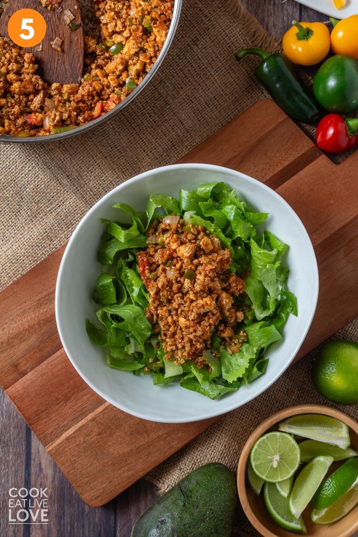 Lettuce and tofu mixture added to a bowl. 