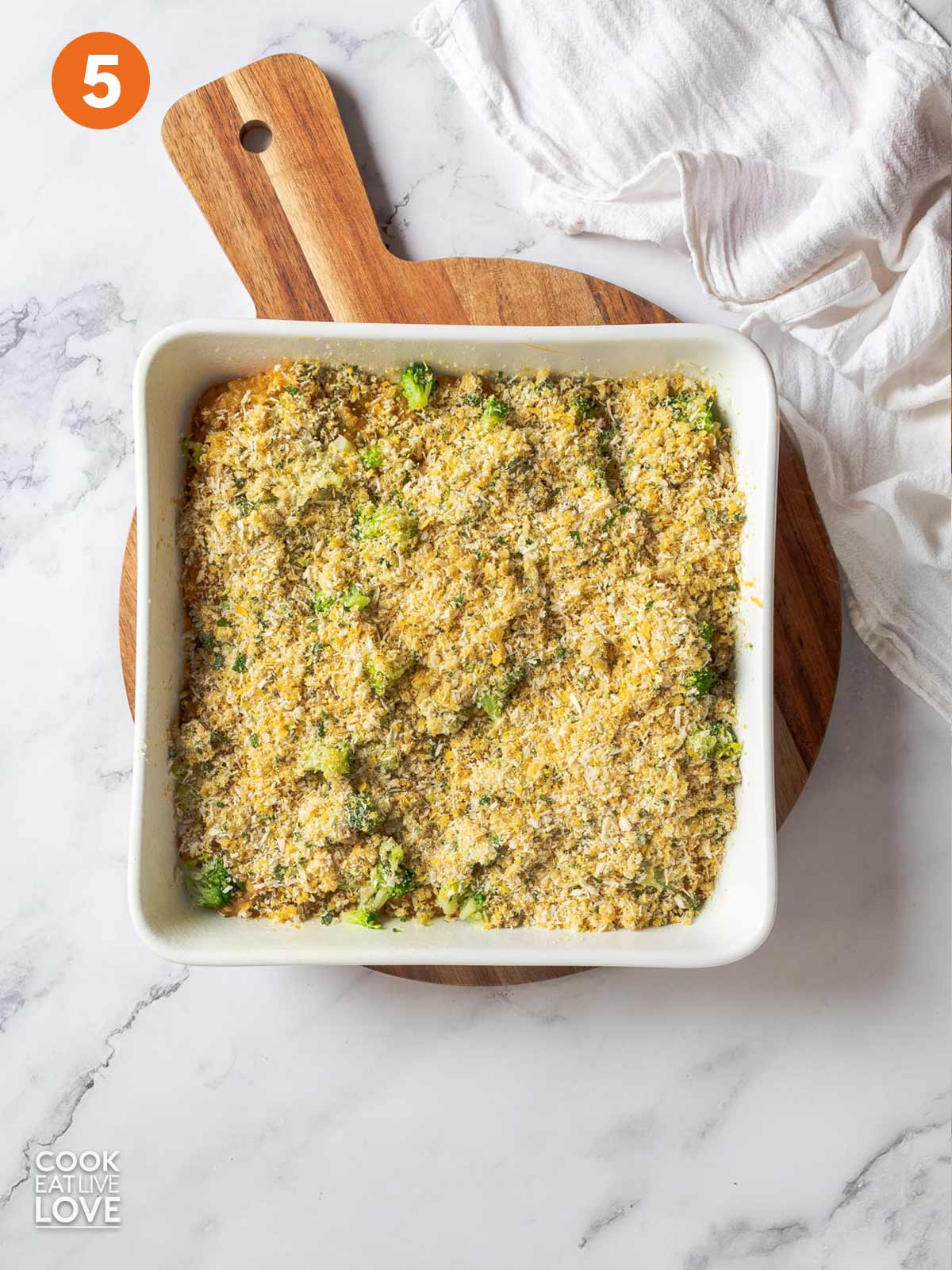 Cheesy broccoli quinoa in the casserole dish with panko topping.