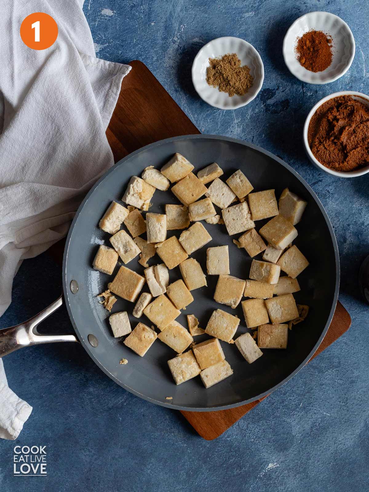Tofu cooking in a skillet.