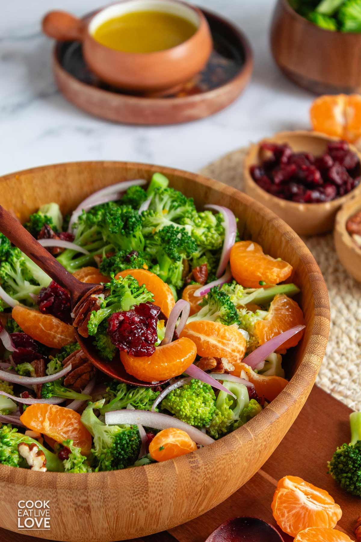 The best broccoli salad with cranberries in a wooden bowl on the table.