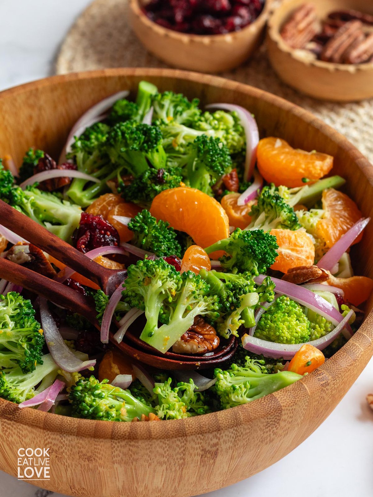 A closeup of cranberry broccoli salad in a wooden bowl.