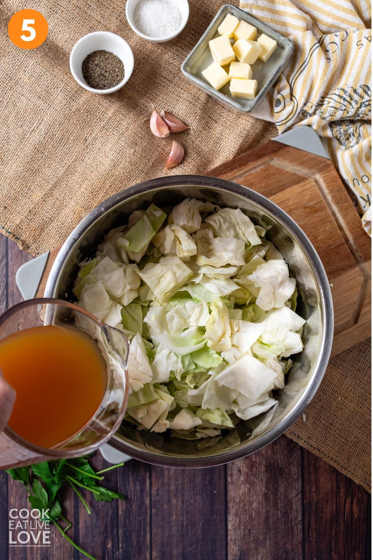 Pouring the broth into the cabbage in the Instant Pot.