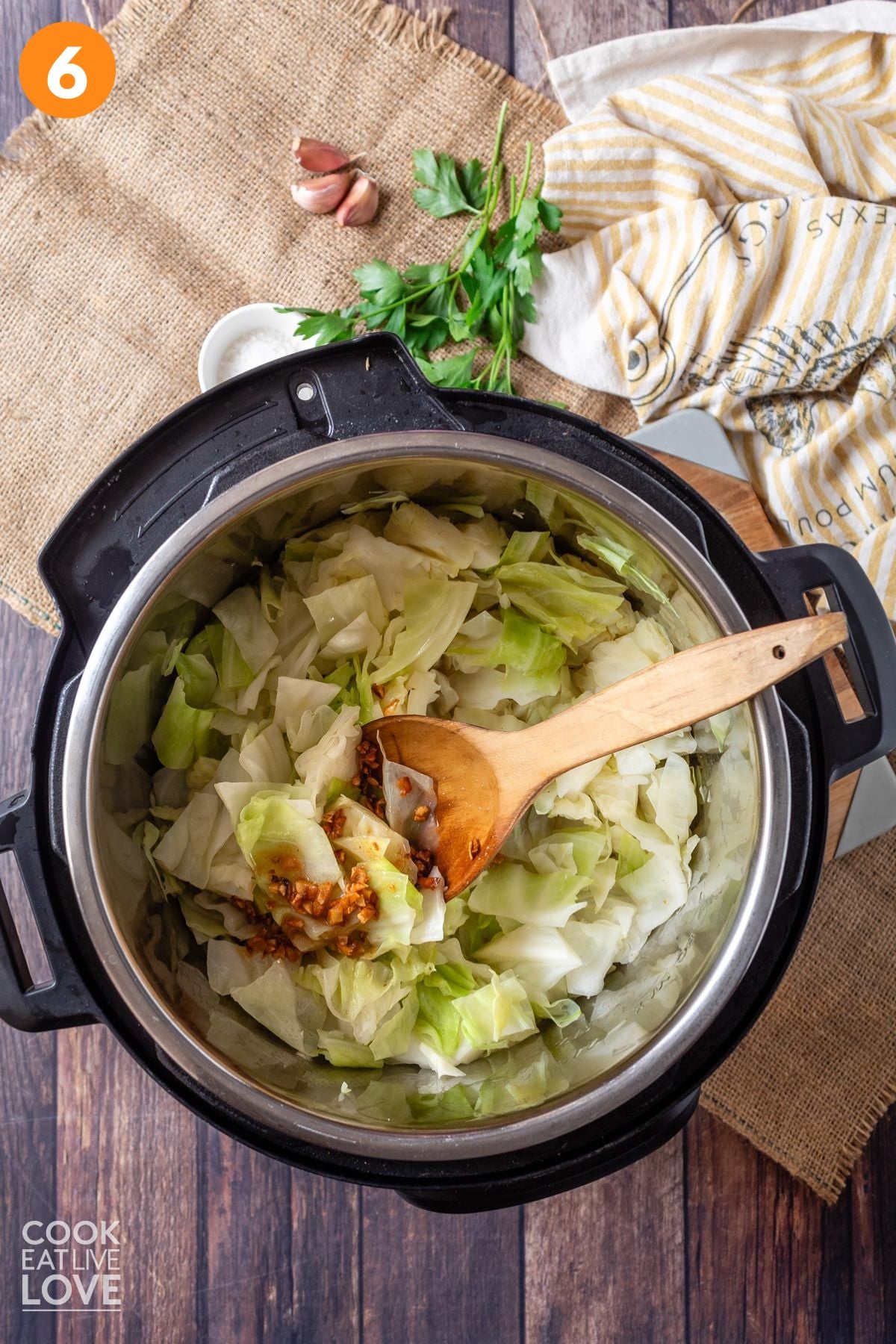Butter and garlic mixture added to cooked cabbage in the Instant Pot.