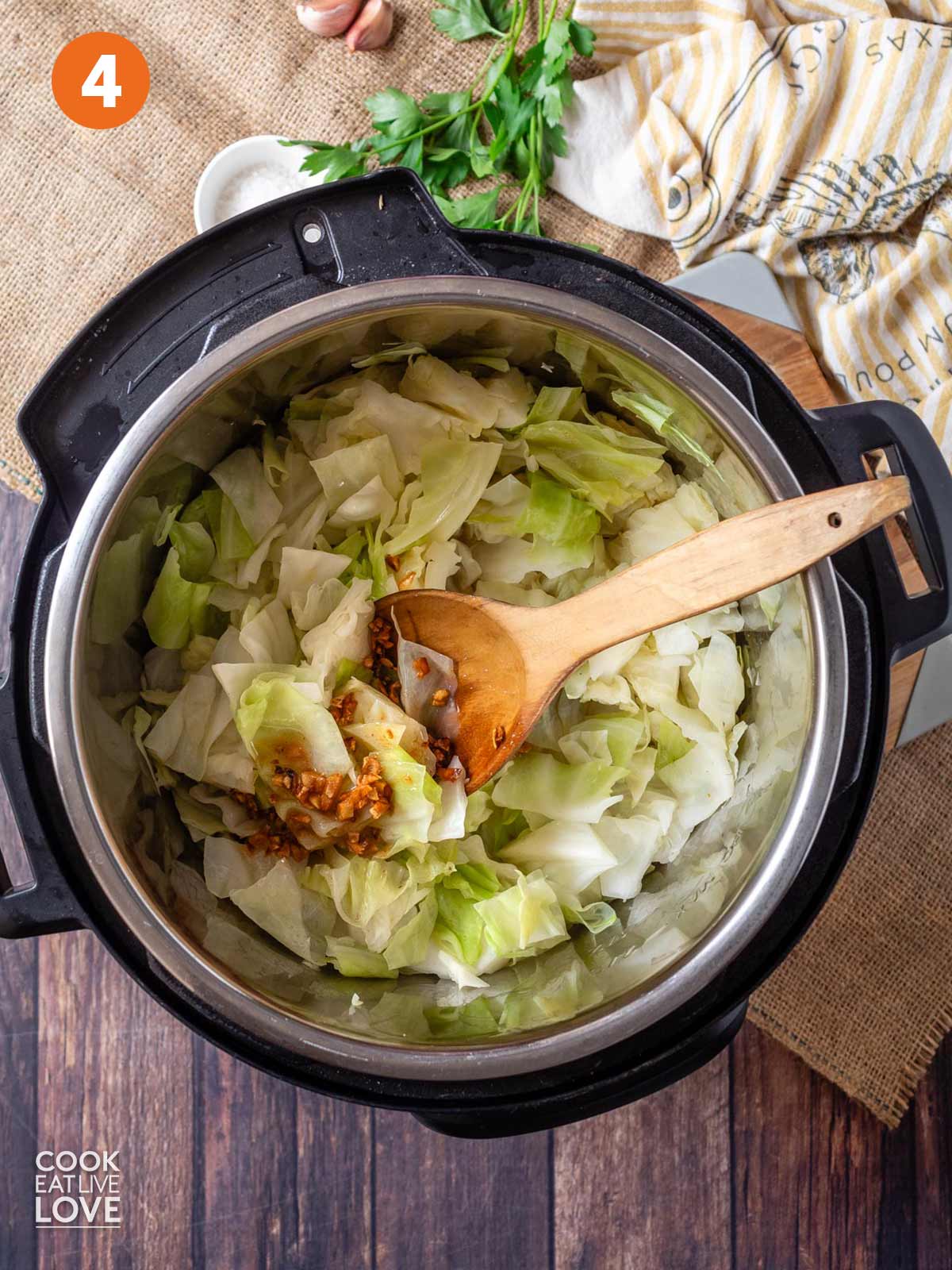 Steamed cabbage in the pressure cooker with garlic butter added.
