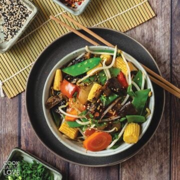 Instant pot stir fry vegetables in a bowl with chopsticks off to the side.