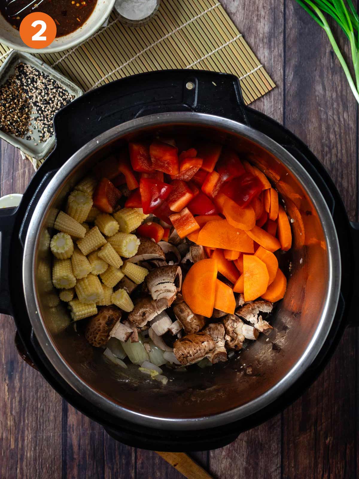 Carrots, bell pepper, corn, and mushrooms added to the instant pot.