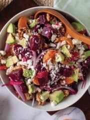 Pickled beet salad in a bowl on the table with a spoon.
