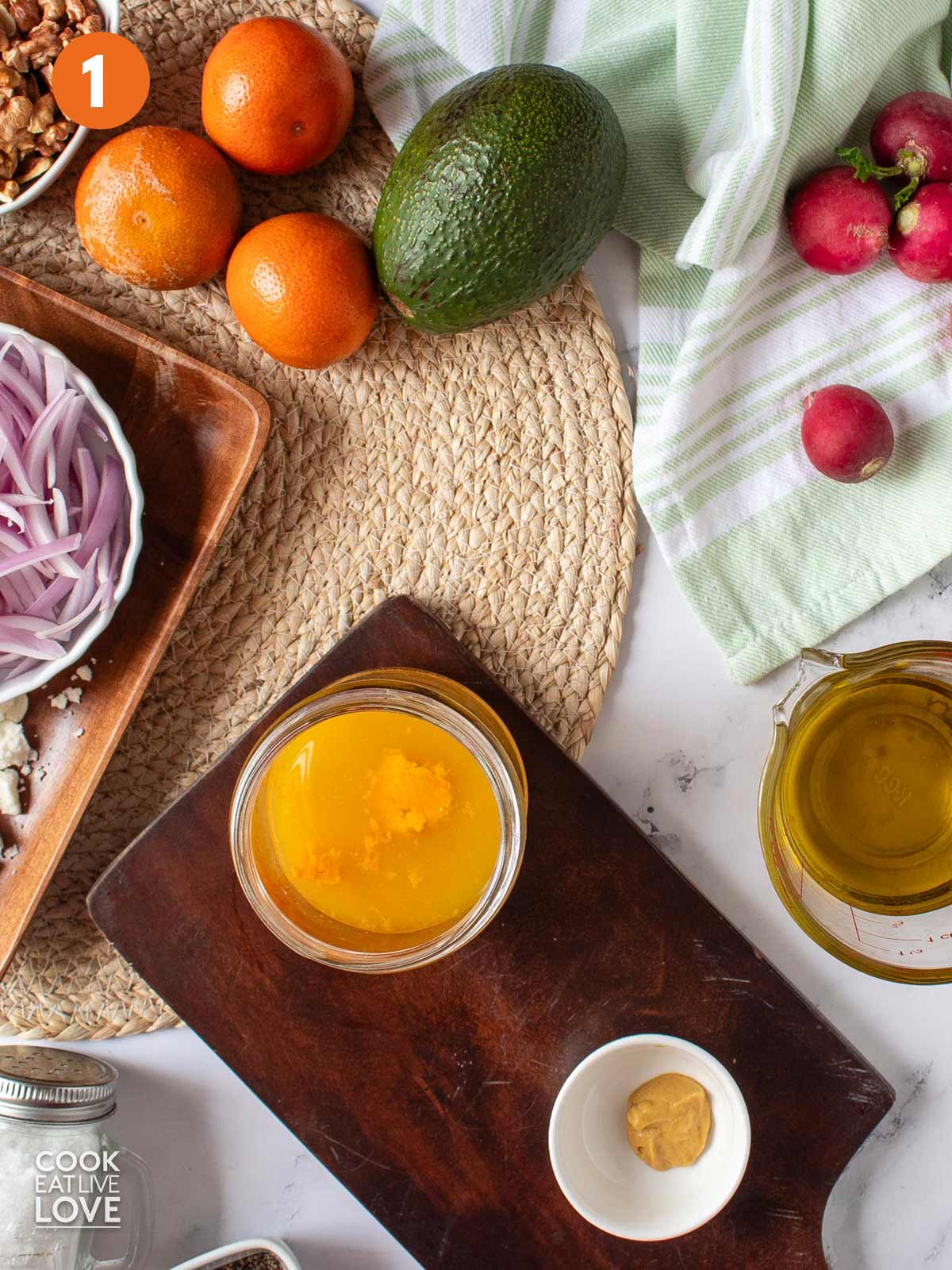 Adding the ingredients to a jar to make the citrus vinaigrette for a salad with pickled beets.