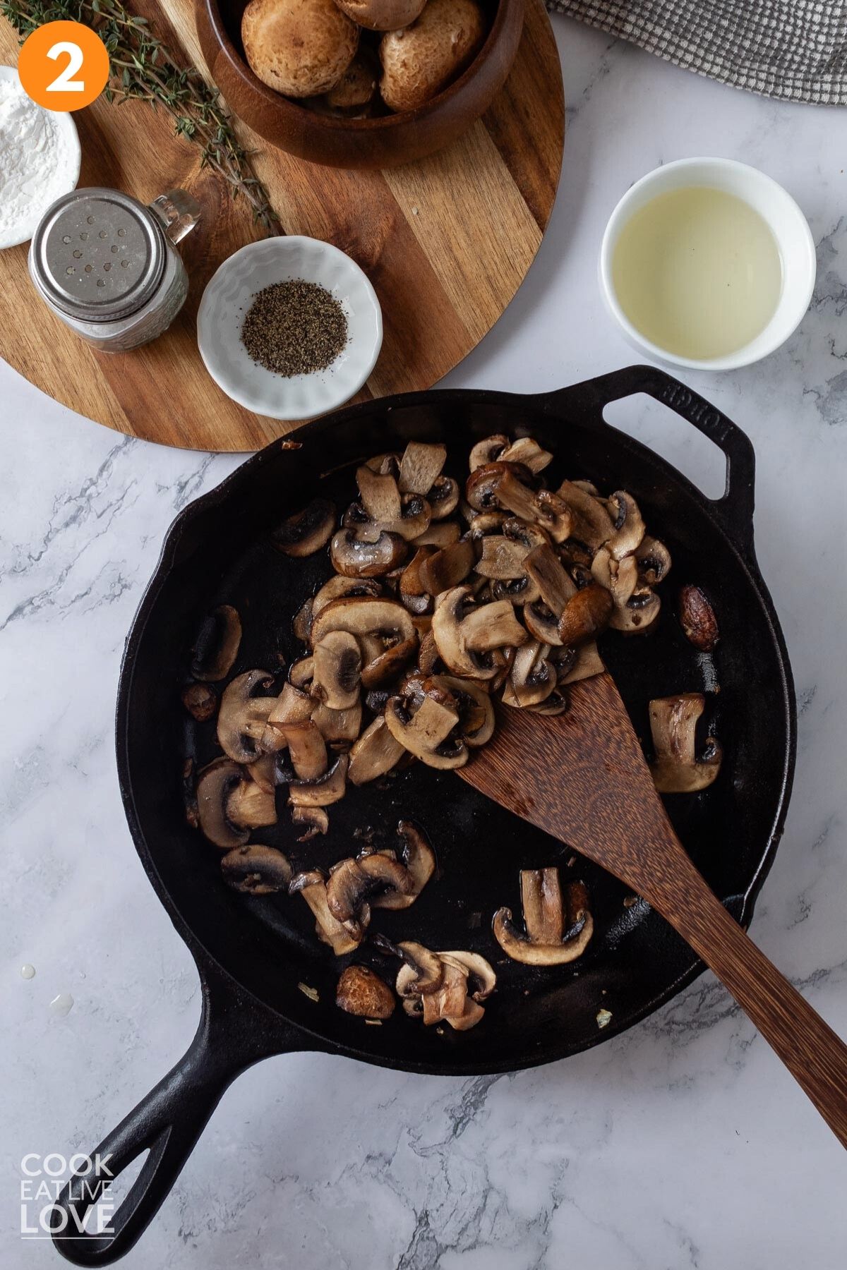 Mushrooms added to the skillet to cook. 