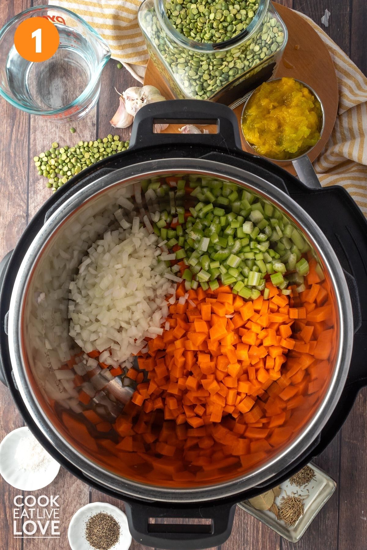 Overhead of onions, carrots, and celery in an instant pot.