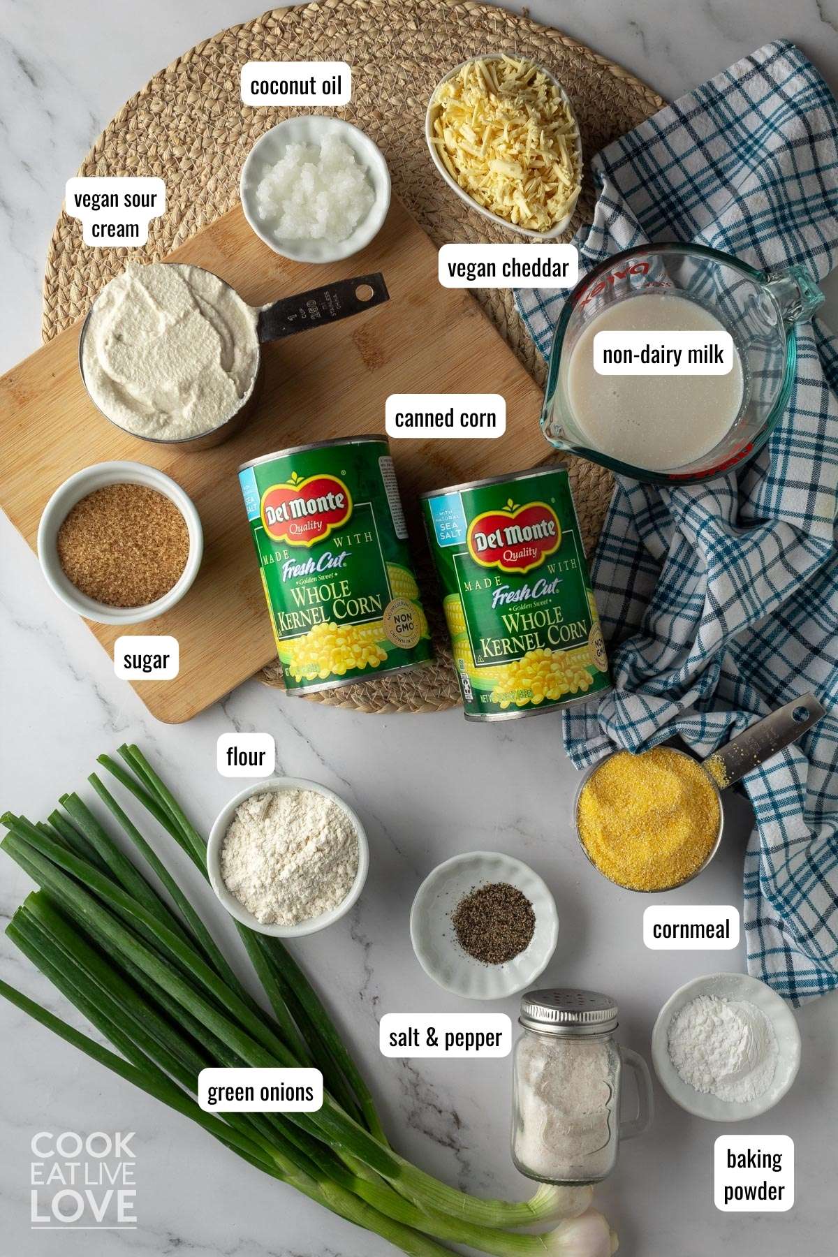 Overhead shot of ingredients needed to make vegan corn casserole with their names listed near them in text boxes.